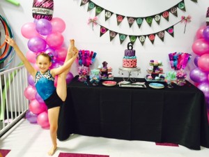 girl doing gymnastic exercise standing next to party arrangements